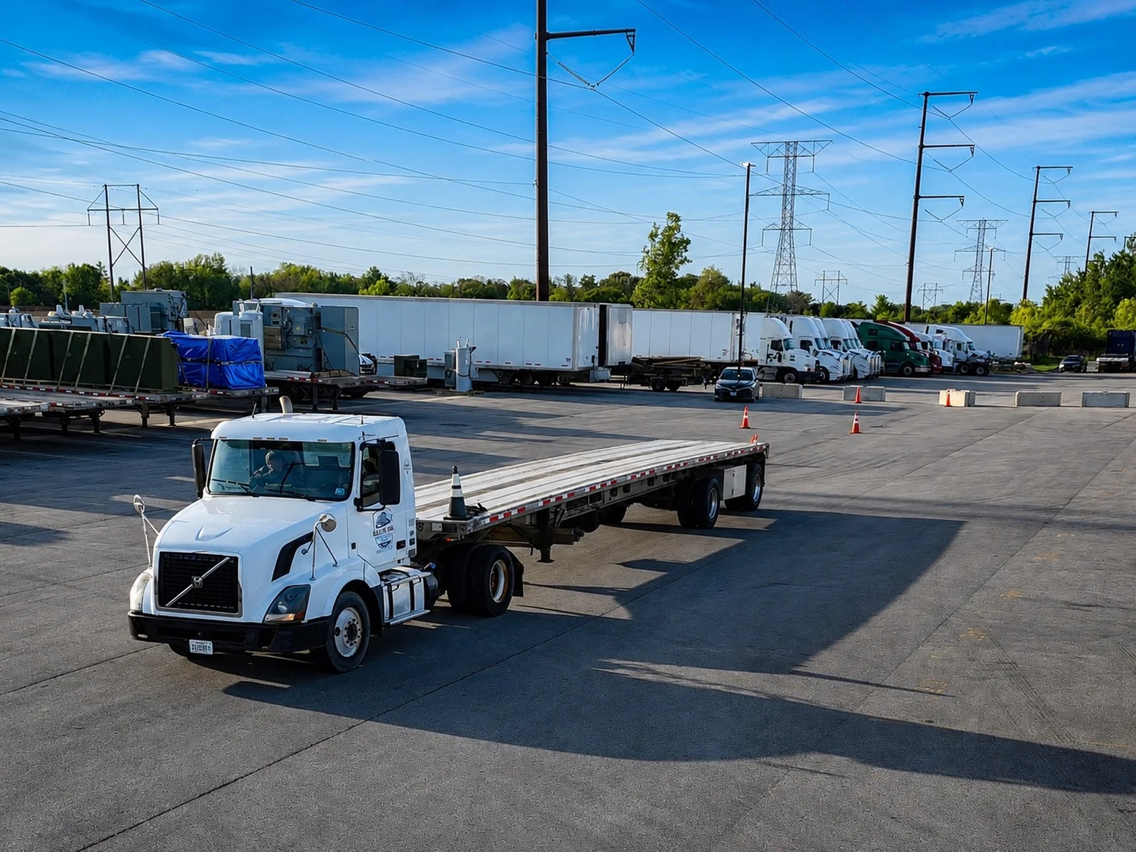 All-In CDL flatbed truck driving through the training yard past a row of parked trailers